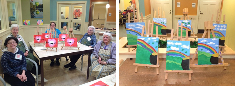 left: a group of women sitting at a table displaying their valentine's day paintings.
right: a group of rainbow and pot of gold paintings sitting on a table top